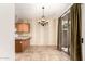 Bright dining area with decorative chandelier, sliding glass doors, and access to the kitchen at 1944 N Lazona Dr, Mesa, AZ 85203