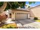 Inviting two-story home with a spacious garage, well-maintained landscaping, and neutral exterior paint at 1944 N Lazona Dr, Mesa, AZ 85203
