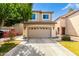 Inviting two-story home with a spacious garage, well-maintained landscaping, and neutral exterior paint at 1944 N Lazona Dr, Mesa, AZ 85203