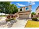 Inviting two-story home with a spacious garage, well-maintained landscaping, and neutral exterior paint at 1944 N Lazona Dr, Mesa, AZ 85203