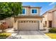 Inviting two-story home with a spacious garage, well-maintained landscaping, and neutral exterior paint at 1944 N Lazona Dr, Mesa, AZ 85203