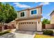 Inviting two-story home with a spacious garage, well-maintained landscaping, and neutral exterior paint at 1944 N Lazona Dr, Mesa, AZ 85203