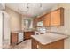 Traditional kitchen with wooden cabinets, white appliances, track lighting, and neutral countertops at 1944 N Lazona Dr, Mesa, AZ 85203