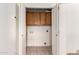 A laundry room features cabinets for storage with open double doors at 1944 N Lazona Dr, Mesa, AZ 85203