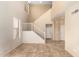 Neutral living room featuring a staircase, neutral tile floors, and views into adjacent spaces at 1944 N Lazona Dr, Mesa, AZ 85203