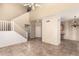 Spacious living room featuring a staircase, neutral tile floors, and views into adjacent spaces at 1944 N Lazona Dr, Mesa, AZ 85203