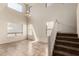 Bright living room with soaring ceilings, large windows, a ceiling fan, and a staircase at 1944 N Lazona Dr, Mesa, AZ 85203