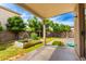Covered patio overlooking a beautiful backyard with lush greenery and a charming garden at 1944 N Lazona Dr, Mesa, AZ 85203