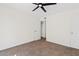 Neutral bedroom features plush carpet, ceiling fan, and closet at 2229 N Middlecoff Dr, Mesa, AZ 85215