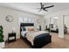 Comfortable bedroom features a ceiling fan, neutral paint, and mirrored closet at 2229 N Middlecoff Dr, Mesa, AZ 85215