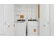 Convenient laundry room with washer, dryer, and shelving for storage at 2229 N Middlecoff Dr, Mesa, AZ 85215