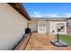 Private patio with stone pavers, mature landscaping, and convenient access to the home's entrance at 2229 N Middlecoff Dr, Mesa, AZ 85215