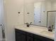 Bathroom with double sink vanity, white countertop, black fixtures, and a large mirror at 22392 W Monona Ln, Surprise, AZ 85387