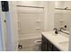 Bathroom featuring double sinks, white countertop, black hardware, and a shower-tub combination at 22392 W Monona Ln, Surprise, AZ 85387