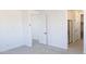 Bright bedroom featuring white walls, carpeted floors, and access to a bathroom with a glass shower at 22392 W Monona Ln, Surprise, AZ 85387