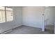 Bright bedroom featuring neutral carpet, white walls, and a window with neighborhood views at 22392 W Monona Ln, Surprise, AZ 85387