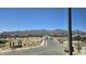 Community view featuring a playground, park, and mountain views in the distance at 22392 W Monona Ln, Surprise, AZ 85387