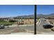 A vibrant community park with lush green space, playground, and picnic area, set against a mountain backdrop at 22392 W Monona Ln, Surprise, AZ 85387