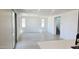 Open-concept living space with sliding glass doors, white walls, and wood-style floors at 22392 W Monona Ln, Surprise, AZ 85387