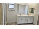Elegant bathroom featuring a double vanity, a large mirror and a glass-enclosed shower at 22400 W Monona Ln, Surprise, AZ 85387