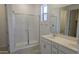 Stylish bathroom featuring a double vanity and glass enclosed shower at 22400 W Monona Ln, Surprise, AZ 85387