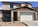 Charming two-story home with a two car garage and stone accents on the column supports at 22400 W Monona Ln, Surprise, AZ 85387