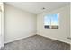 A bedroom features neutral carpet, a large window, and an open door at 23259 S 194Th Dr, Buckeye, AZ 85326