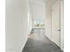Bright hallway with wood-look tile flooring and leads into a room with ample natural light at 23259 S 194Th Dr, Buckeye, AZ 85326