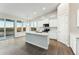 Bright kitchen features white cabinets, an island with a sink, and large windows to enjoy the desert view at 23259 S 194Th Dr, Buckeye, AZ 85326