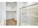 Bathroom featuring a glass enclosed shower, walk in closet, and tile flooring at 24610 W Bowker St, Buckeye, AZ 85326