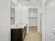 Bright bathroom with a double sink vanity, large mirror, walk in shower, and walk in closet at 24610 W Bowker St, Buckeye, AZ 85326