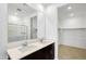Contemporary bathroom with a double vanity, large mirror, walk-in shower, and a walk-in closet at 24610 W Bowker St, Buckeye, AZ 85326