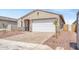 Attractive home featuring a 2-car garage, a welcoming entrance, and decorative rock landscaping at 24610 W Bowker St, Buckeye, AZ 85326