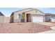 Inviting home with a brick driveway, neutral stucco, a white garage door, and desert landscaping at 24610 W Bowker St, Buckeye, AZ 85326