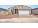 Charming single-story home with a two-car garage, low maintenance landscaping, and a well-maintained lawn at 24610 W Bowker St, Buckeye, AZ 85326
