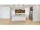Open-concept kitchen with a large island, stainless steel appliances, dark cabinets, and tile flooring at 24610 W Bowker St, Buckeye, AZ 85326