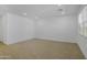 Spacious living room featuring wood-look tile flooring, recessed lighting, neutral walls, and a large window at 24610 W Bowker St, Buckeye, AZ 85326