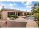 Backyard with a built-in grill, desert landscaping and a beautiful pool, perfect for outdoor living and entertaining at 2612 S Jacob St, Gilbert, AZ 85295