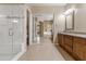 Bathroom featuring a large shower, dual sink vanity with granite counters and tiled flooring at 2612 S Jacob St, Gilbert, AZ 85295