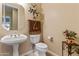 Elegant powder room featuring a pedestal sink, decorative mirror, and neutral tones for a clean, inviting space at 2612 S Jacob St, Gilbert, AZ 85295