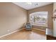 Bedroom featuring wood floors, neutral walls, a ceiling fan, and a chair at 2612 S Jacob St, Gilbert, AZ 85295