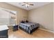Cozy bedroom with natural light, ceiling fan, and wood floors creating a comfortable and inviting retreat at 2612 S Jacob St, Gilbert, AZ 85295