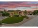 Beautiful single-story home with desert landscaping and a two-car garage under a colorful sky at 2612 S Jacob St, Gilbert, AZ 85295