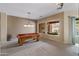 Spacious game room featuring a billiard table, neutral walls and carpet, and a beautiful pool view at 2612 S Jacob St, Gilbert, AZ 85295