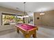 Spacious game room featuring a pool table and large windows overlooking the pool at 2612 S Jacob St, Gilbert, AZ 85295