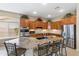 Well-appointed kitchen featuring stainless steel appliances, a granite island, and wood cabinets at 2612 S Jacob St, Gilbert, AZ 85295