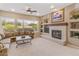 Well-lit living room featuring a fireplace, comfortable seating, and a large window with garden views at 2612 S Jacob St, Gilbert, AZ 85295