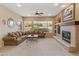 Cozy living room with plush seating, fireplace, and ample natural light from large windows at 2612 S Jacob St, Gilbert, AZ 85295