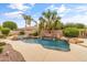 Stunning pool featuring a rock waterfall, spa and mature landscaping that creates a backyard oasis at 2612 S Jacob St, Gilbert, AZ 85295