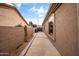 Spacious side yard with a concrete walkway, block wall fencing and low maintenance desert landscaping at 2612 S Jacob St, Gilbert, AZ 85295